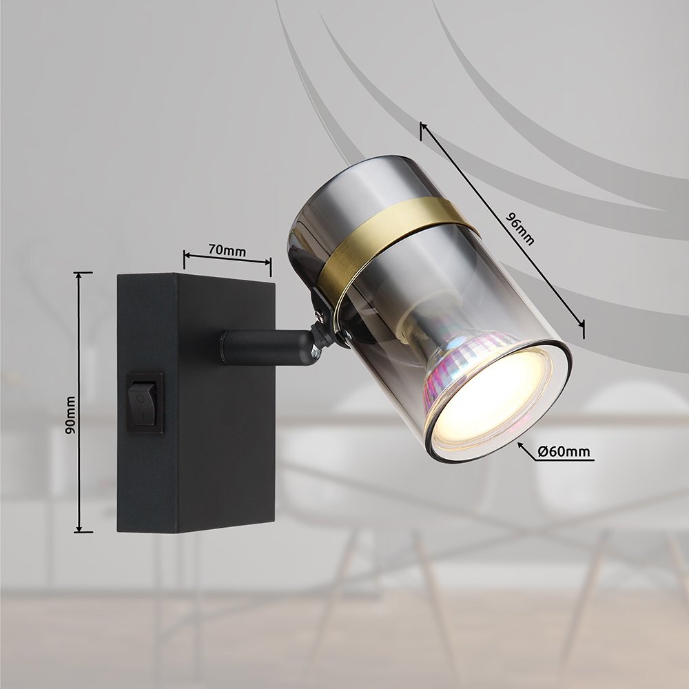 Lampa reflektorowa z czarną matową podstawą i przydymionym szklanym kloszem, z włącznikiem na podstawie. Wymiary: 90mm wysokości, 70mm szerokości podstawy, 96mm długości klosza, 60mm średnicy klosza.