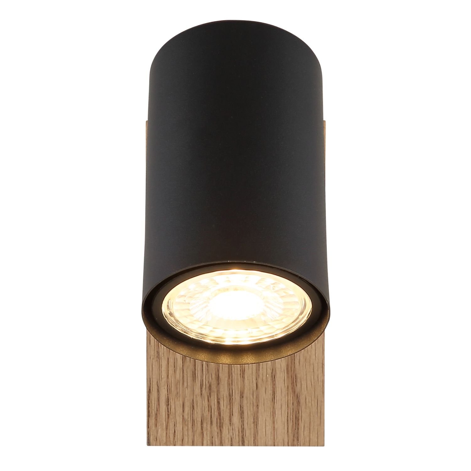 Czarny reflektor sufitowy z drewnianą podstawą, emitujący jasne światło. Lampa ma cylindryczny kształt i nowoczesny design.