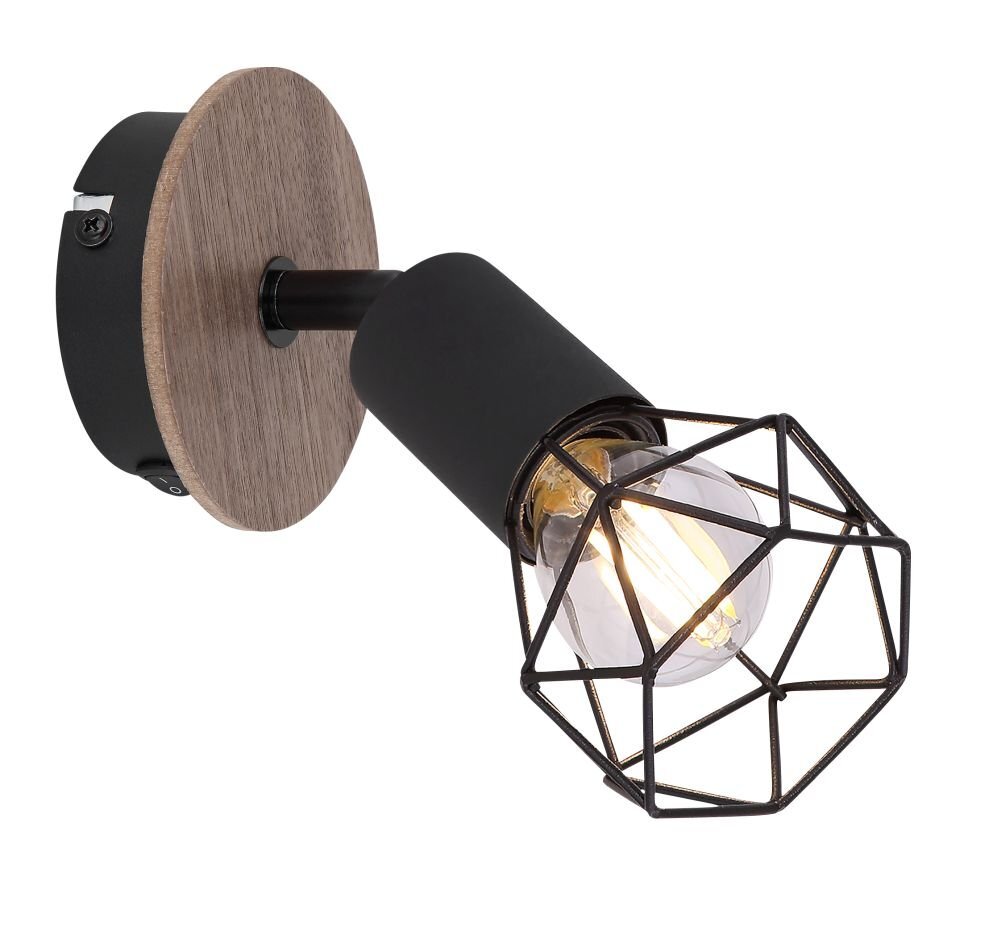 Czarny reflektor z metalowym kloszem w kształcie geometrycznej siatki, zamontowany na okrągłej, brązowej podstawie. Wewnątrz klosza znajduje się żarówka.