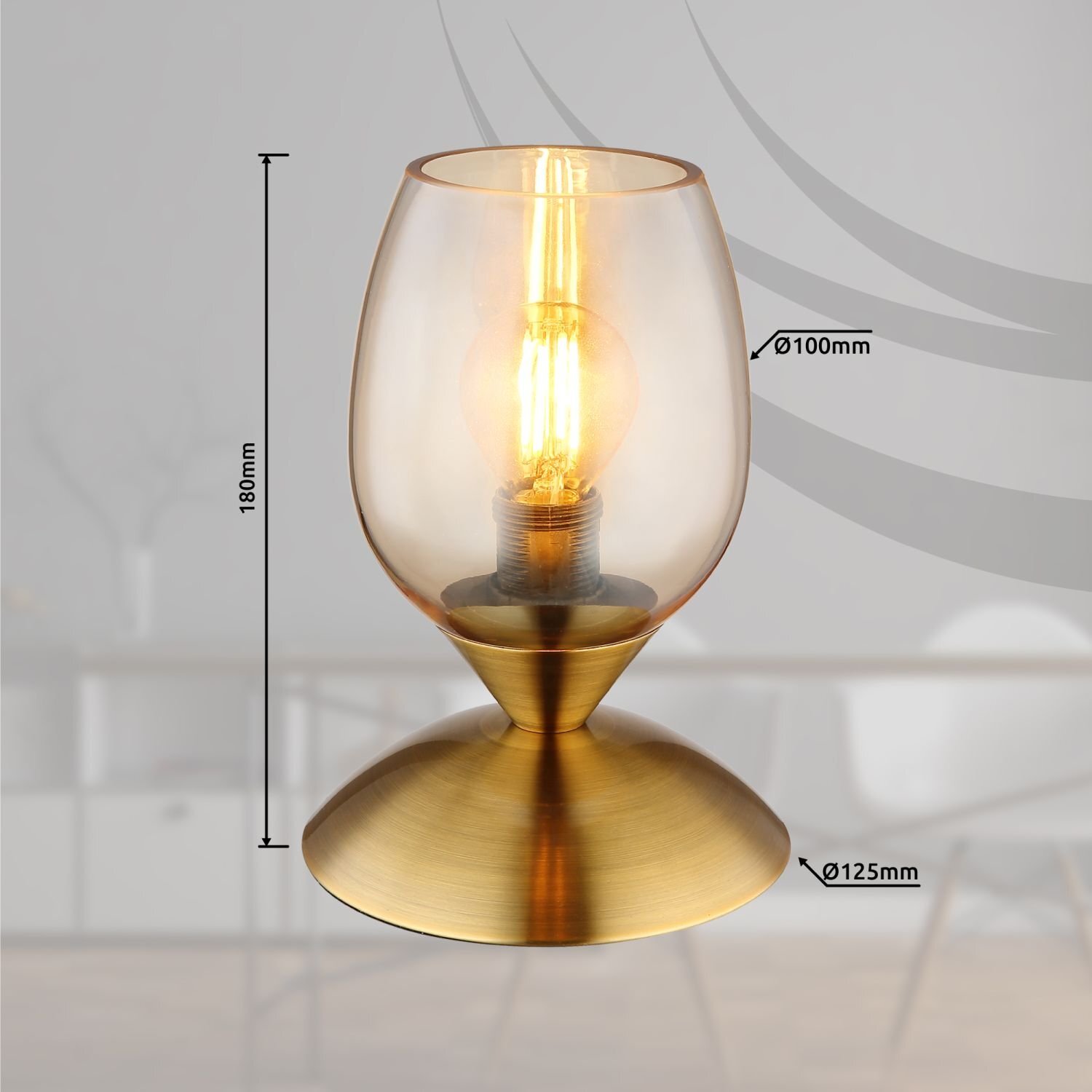 Lampa stołowa z przezroczystym kloszem w kształcie kielicha, z widoczną żarówką wewnątrz. Wymiary: wysokość 180mm, średnica klosza 100mm, średnica podstawy 125mm.