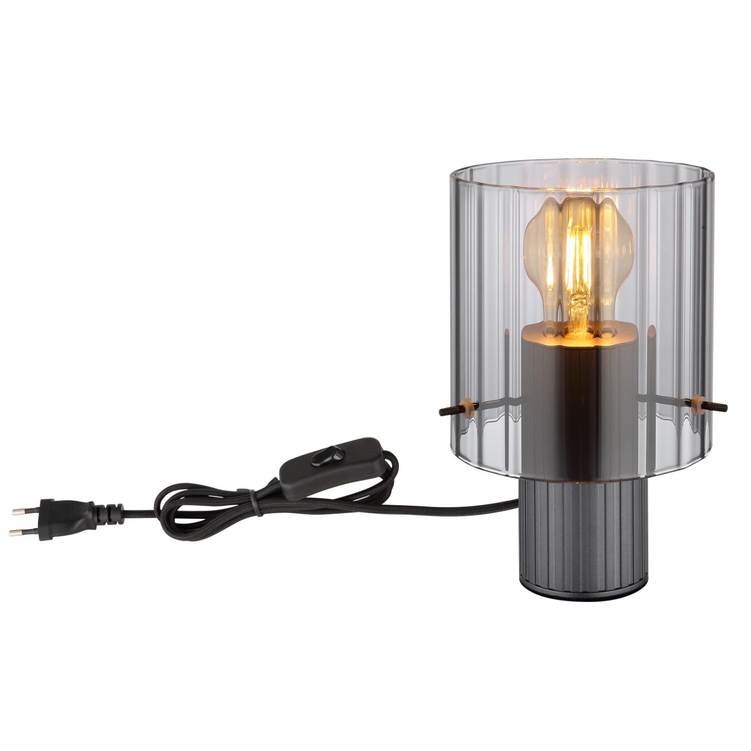 Lampa stołowa z ryflowanym kloszem, przez który widać żarówkę. Obok lampy znajduje się przewód z wtyczką i włącznikiem.