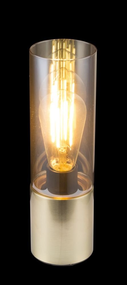 Lampa stołowa z cylindrycznym bursztynowym kloszem i złotą podstawą, wewnątrz widoczna żarówka emitująca ciepłe światło.