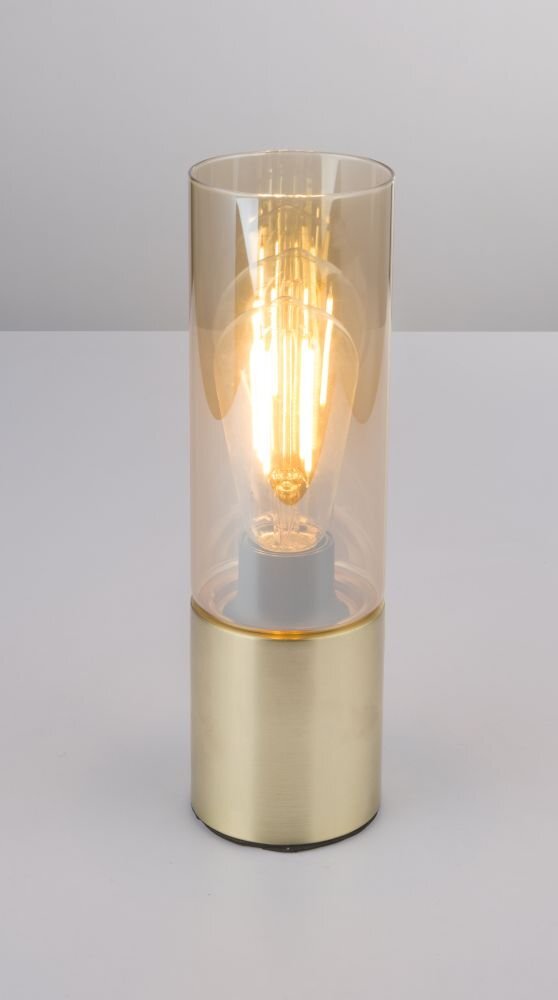 Złota lampa stołowa z bursztynowym szklanym kloszem, w której widoczna jest żarówka. Podstawa lampy jest metaliczna i cylindryczna.