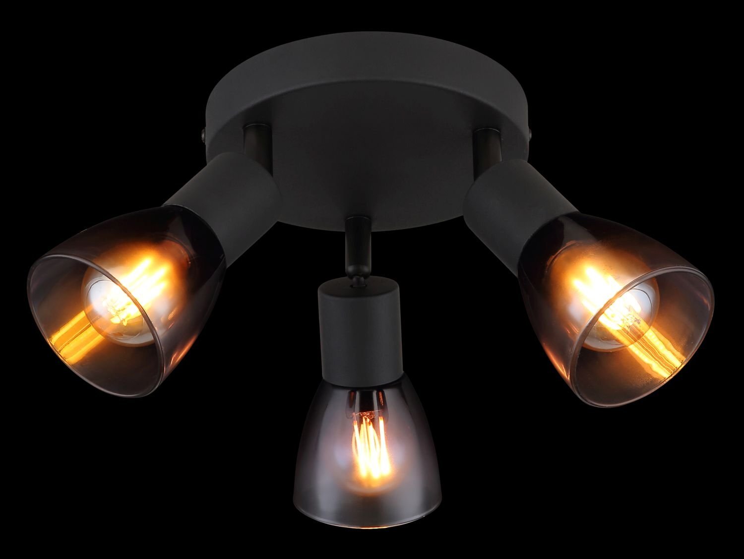 Na obrazie widoczna jest lampa sufitowa z trzema reflektorami, każdy z nich ma przezroczysty klosz i emituje ciepłe światło. Lampa ma ciemną, matową podstawę i nowoczesny design.
