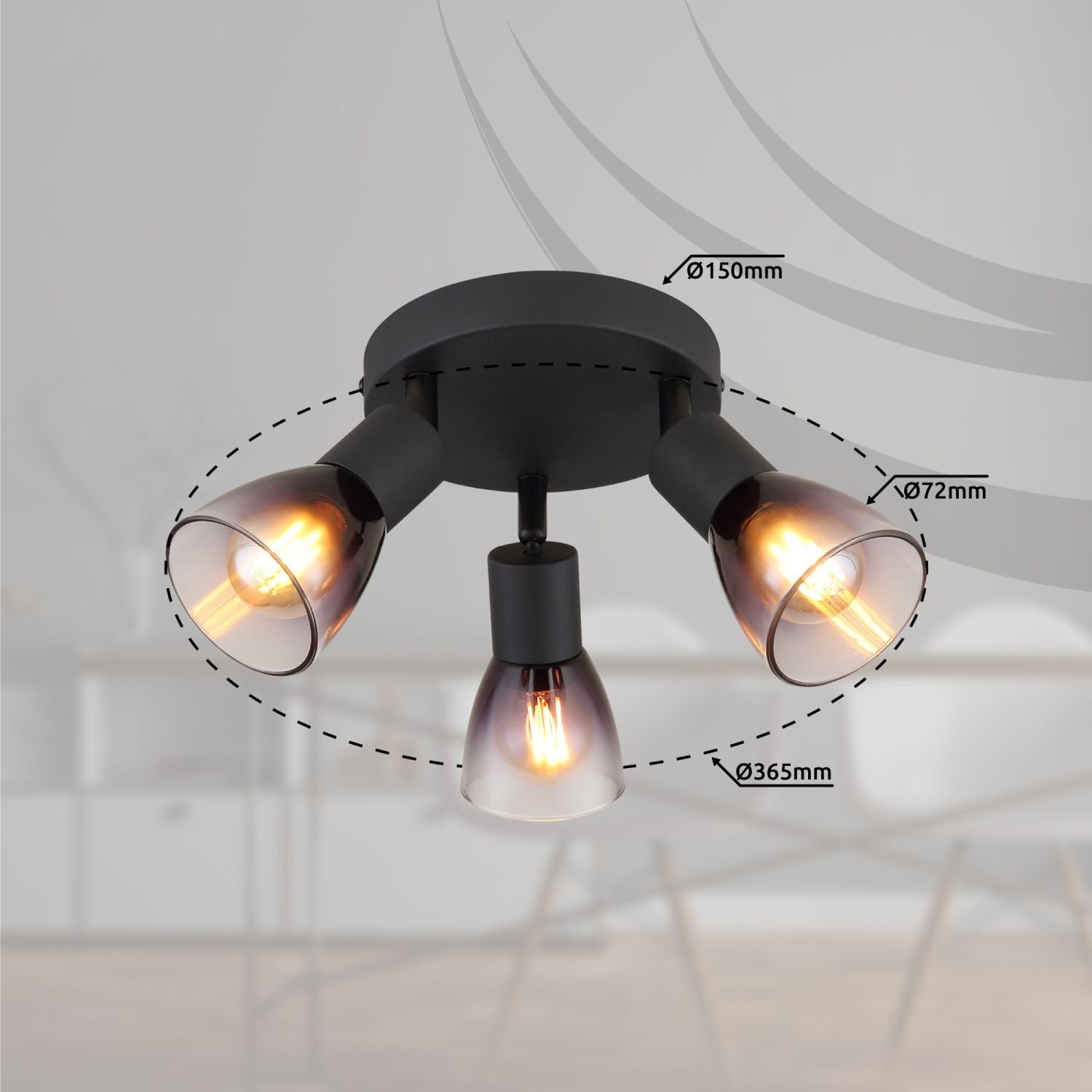 Na obrazie widoczna jest czarna lampa sufitowa z trzema reflektorami, z oznaczeniami wymiarów: Ø150mm, Ø72mm, Ø365mm. W tle znajduje się rozmyte wnętrze z meblami.
