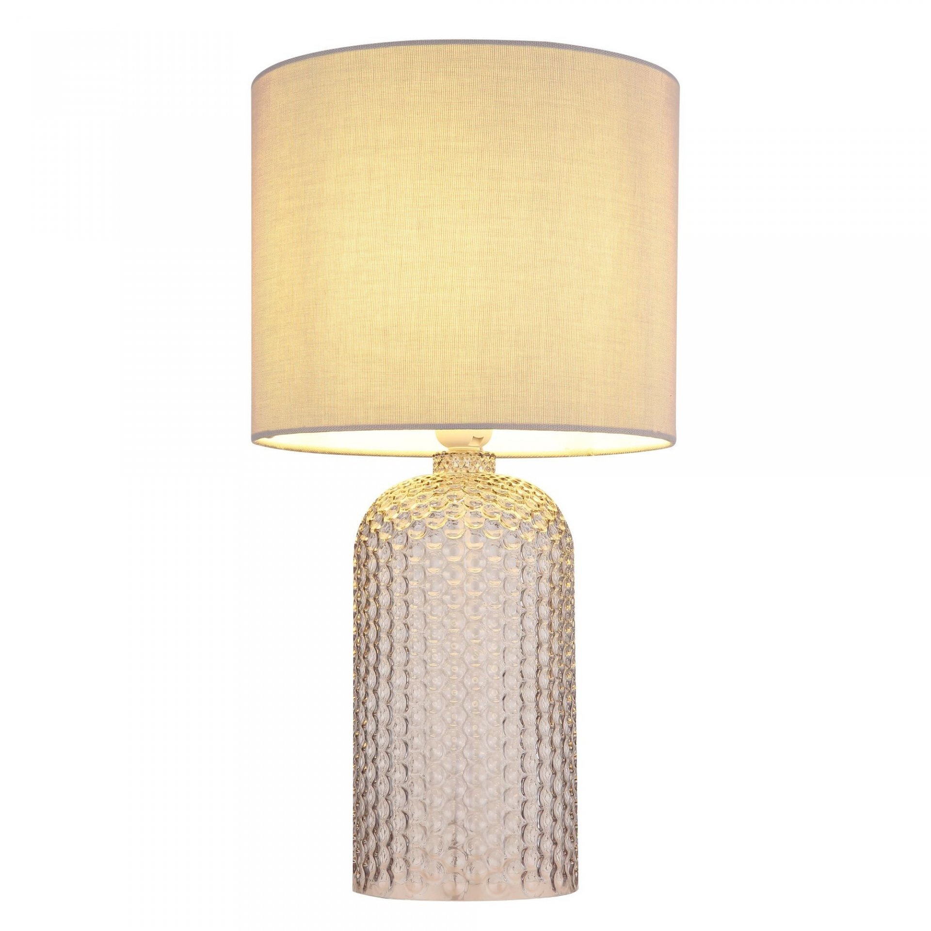 Lampa stołowa z cylindrycznym abażurem w jasnym kolorze i podstawą o fakturze przypominającej bąbelki. Światło lampy jest ciepłe i rozproszone.