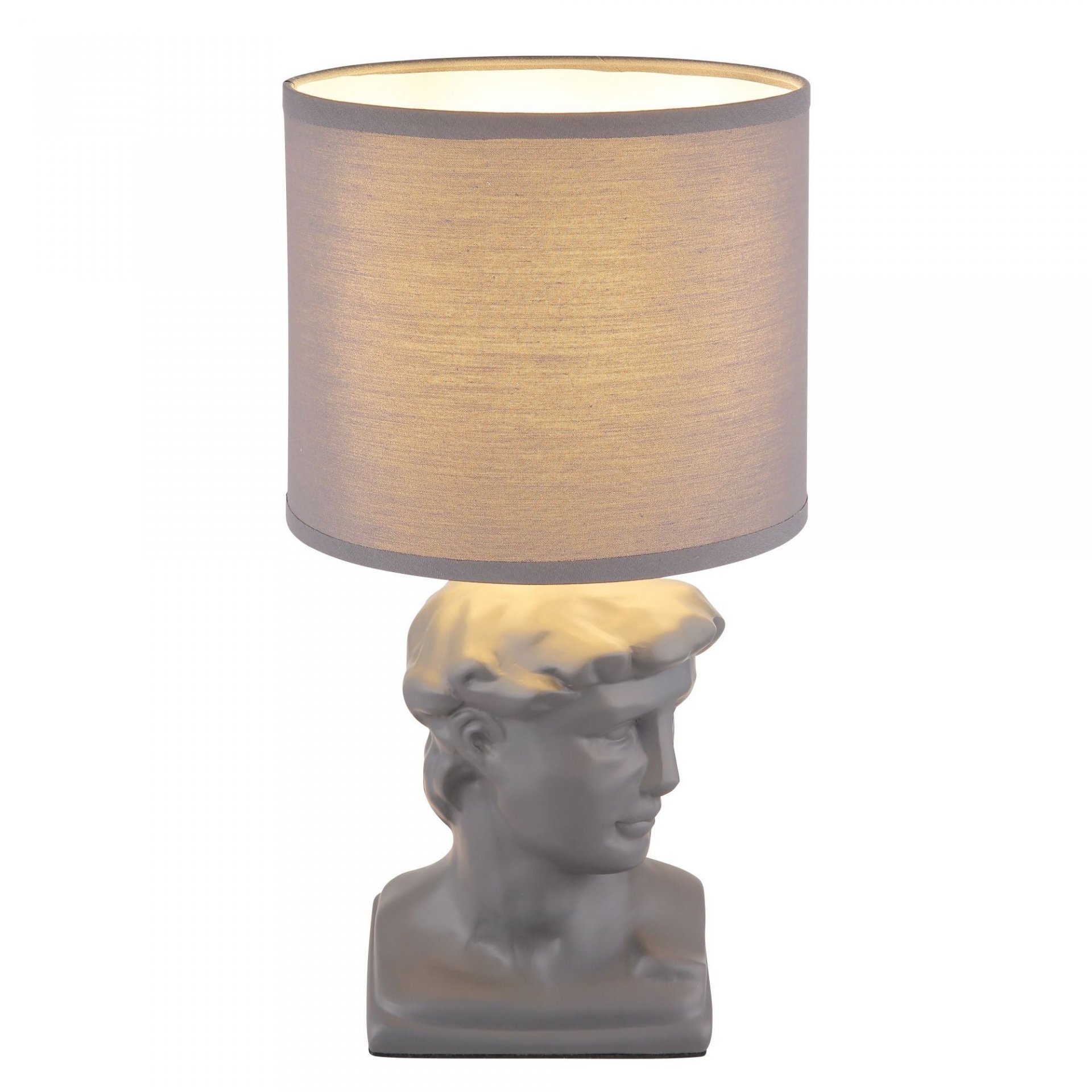 Lampa stołowa z abażurem w kształcie walca, osadzona na podstawie przypominającej popiersie klasycznej rzeźby. Abażur ma jasny kolor, a podstawa jest w odcieniu szarości.