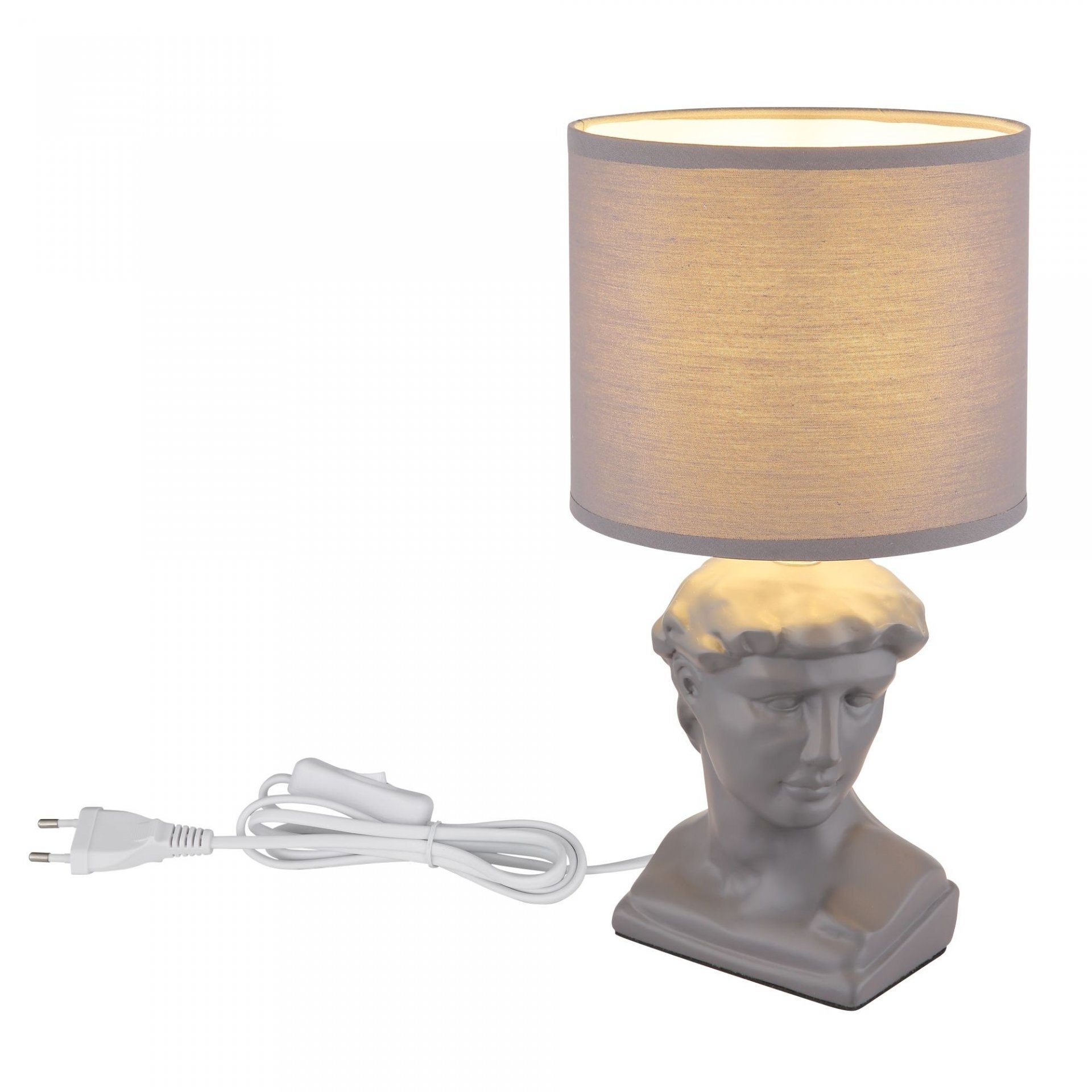 Lampa stołowa z abażurem w kształcie walca w kolorze beżowym, z podstawą w formie popiersia. Do lampy dołączony jest biały przewód z wtyczką i przełącznikiem.