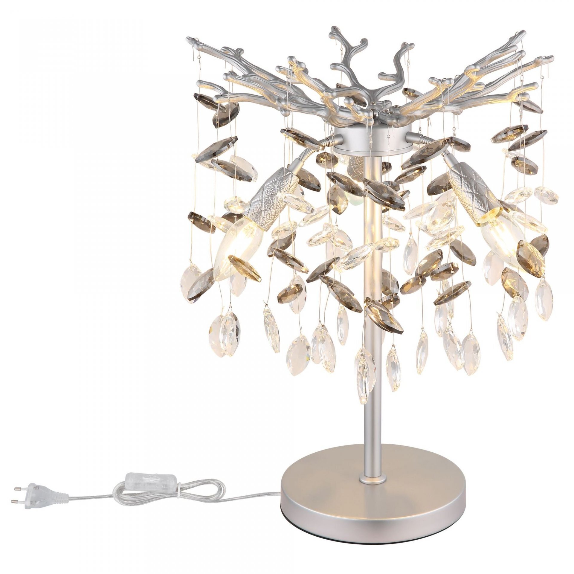 Lampa stołowa z metalową podstawą i ozdobnymi kryształkami zawieszonymi na cienkich linkach. Posiada srebrzyste wykończenie i nowoczesny design.