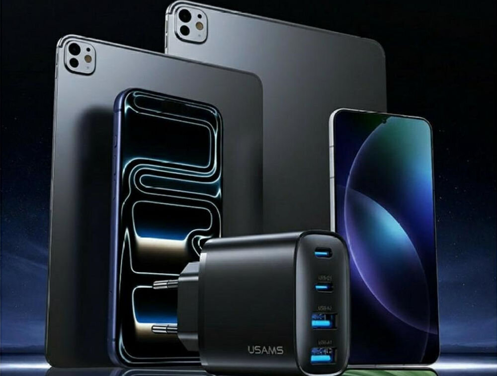 Na obrazie widoczna jest czarna ładowarka sieciowa z trzema portami USB, obok której znajdują się dwa nowoczesne smartfony i dwa tablety. Na ładowarce widnieje napis \'USAMS\'.