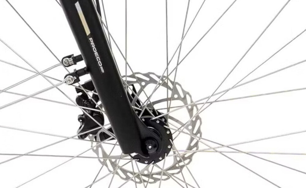 Rower elektryczny ROMET PROECO Easy 28172567-A U17 28 cali Zielony Zbliżenie na tarczę hamulcową roweru z widocznym zaciskiem hamulcowym marki Shimano. W tle widać szprychy koła.