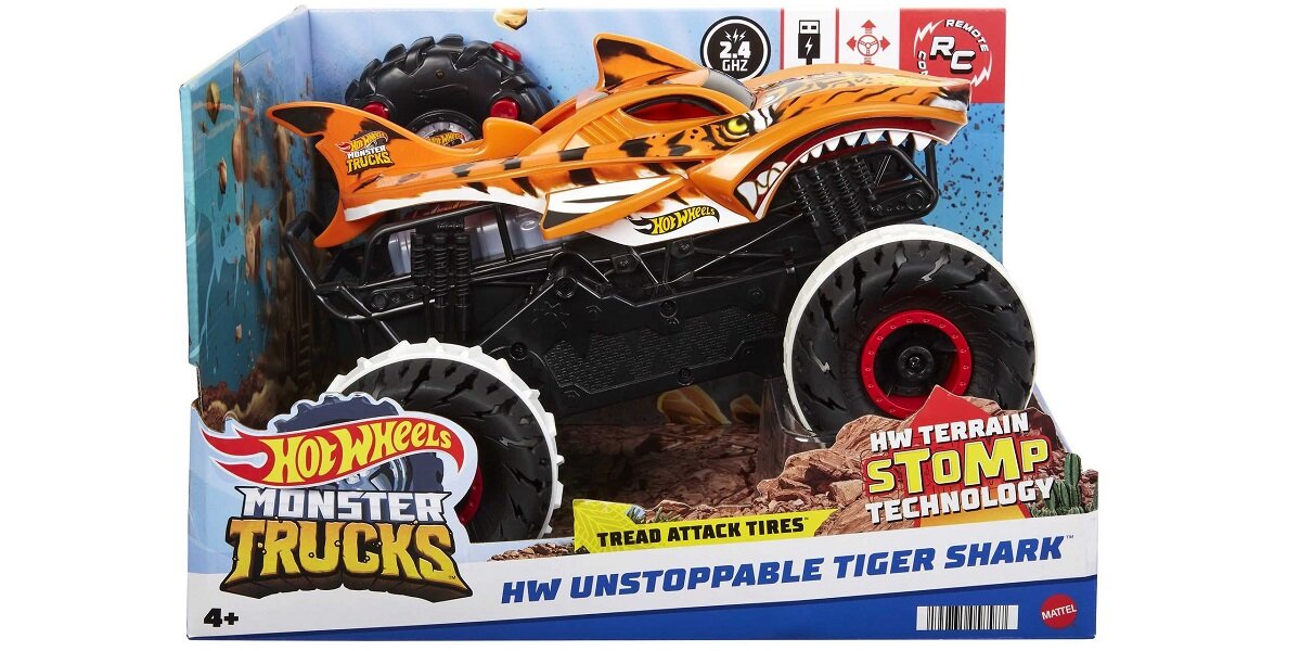 Opakowanie zabawki Hot Wheels Monster Trucks z modelem pojazdu terenowego w kształcie rekina tygrysiego. Na opakowaniu widnieje tekst: \'HW UNSTOPPABLE TIGER SHARK\', \'TREAD ATTACK TIRES\', \'HW TERRAIN STOMP TECHNOLOGY\'.