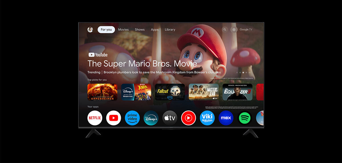 Telewizor wyświetla ekran główny z aplikacjami, w tym YouTube, Netflix, Prime Video, Disney+, Apple TV, Viki, Max i Spotify. Na ekranie widoczny jest film \'The Super Mario Bros. Movie\' oraz różne ikony aplikacji.