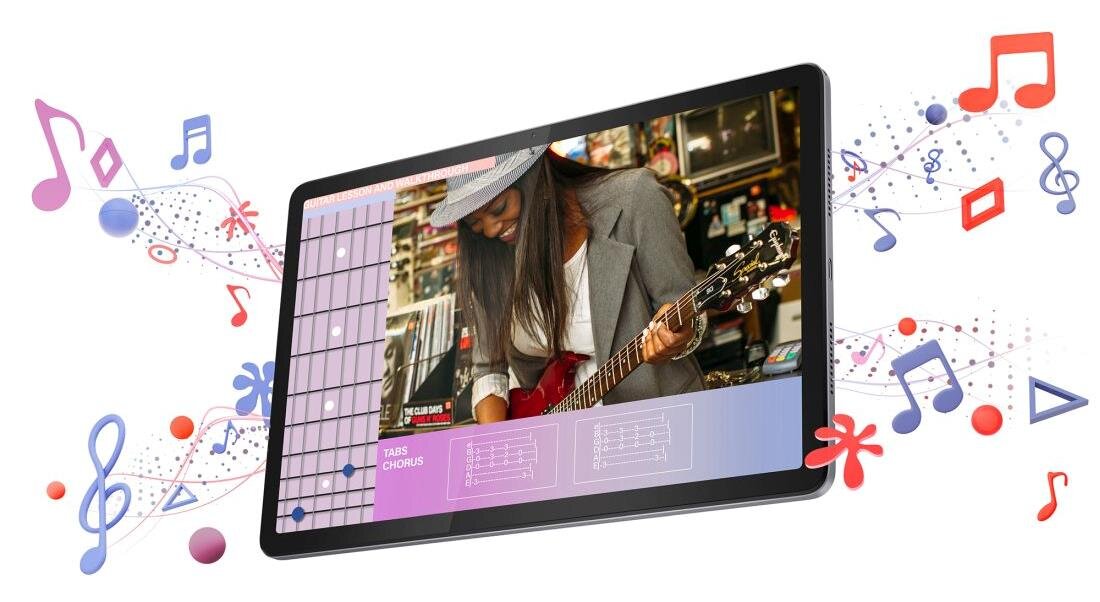 Tablet wyświetla obraz kobiety grającej na gitarze, otoczony kolorowymi nutami i symbolami muzycznymi. Na ekranie widoczne są także elementy interfejsu muzycznego z napisem \'TABIS CHORUS\'.