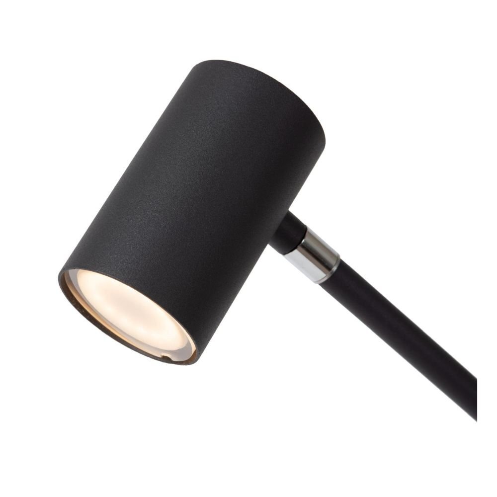 Czarna, cylindryczna głowica lampy z widocznym źródłem światła, zamocowana na metalowym ramieniu. Lampa ma nowoczesny design i matowe wykończenie.