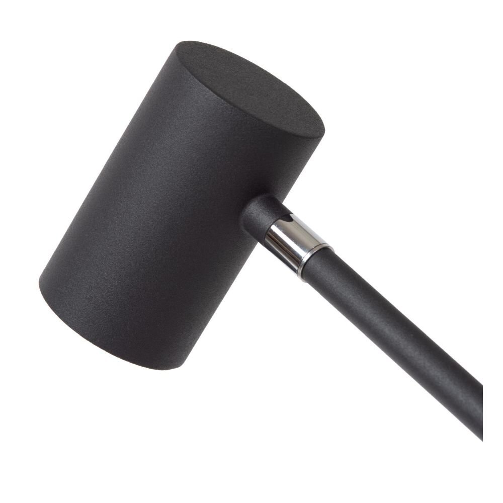 Czarna, cylindryczna głowica lampy z metalowym uchwytem, przymocowana do smukłego ramienia. Powierzchnia jest matowa, a elementy łączenia mają metaliczny połysk.