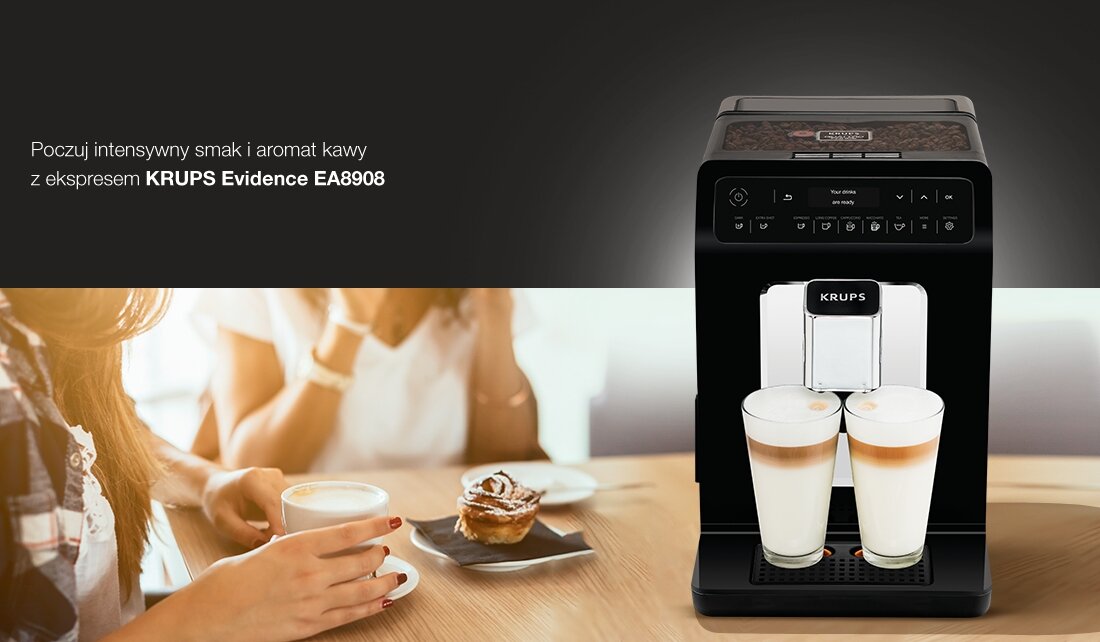 Na obrazie widoczny jest ekspres do kawy z logo KRUPS, przygotowujący dwa napoje z mleczną pianką. Obok znajduje się tekst: \'Poczuj intensywny smak i aromat kawy z ekspresem KRUPS Evidence EA8908\'.