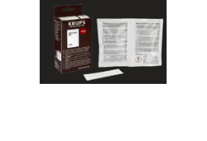 Na obrazie znajduje się opakowanie z napisem \'KRUPS\' oraz otwarta ulotka z tekstem. Obok leży biały pasek, prawdopodobnie związany z produktem.