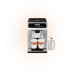 Ekspres do kawy z dwoma filiżankami wypełnionymi napojem mlecznym, obok znajduje się metalowy pojemnik z rurką. Na górze urządzenia widoczne są przyciski i wyświetlacz.