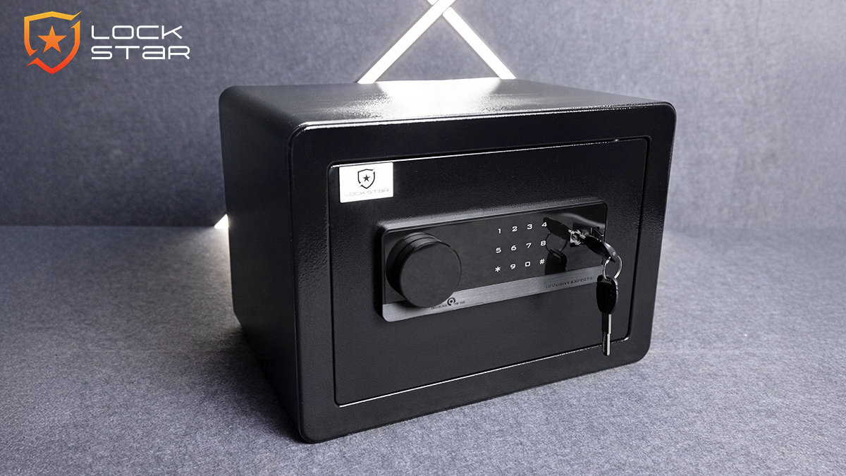 Czarny sejf elektroniczny z panelem numerycznym i kluczem w zamku. W lewym górnym rogu widoczne jest logo \'LOCK STAR\'.