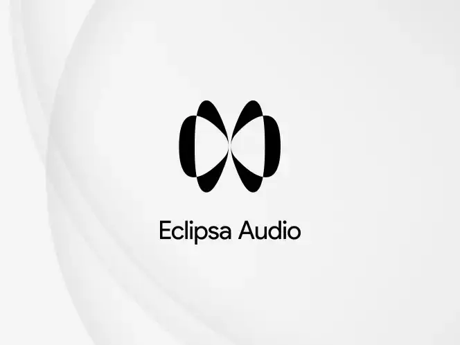 2026-eclipsa-audio-white 664x498 Logo przedstawia czarno-biały symbol złożony z dwóch owalnych kształtów oraz napis \'Eclipsa Audio\' poniżej.