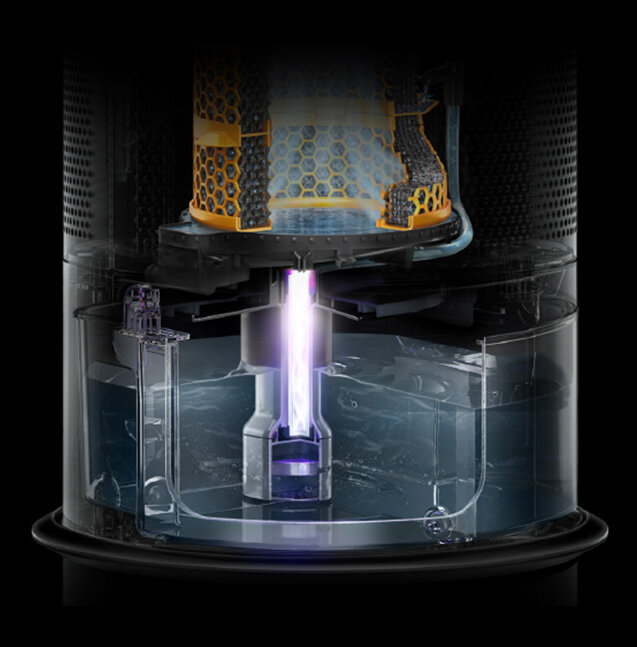 Wnętrze urządzenia z widocznym systemem filtracji i przepływem powietrza. Widać elementy konstrukcyjne, w tym przezroczysty zbiornik z cieczą i fioletowy strumień światła.