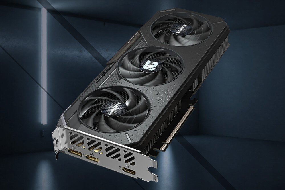 Karta graficzna GIGABYTE Radeon RX 9060XT GAMING OC 16G Karta graficzna z widocznym zestawem wyjść wideo: dwa porty DisplayPort i jeden HDMI, ukazana w zawieszeniu na tle ciemnego pomieszczenia z podświetleniem LED, płytka PCB, konstrukcja