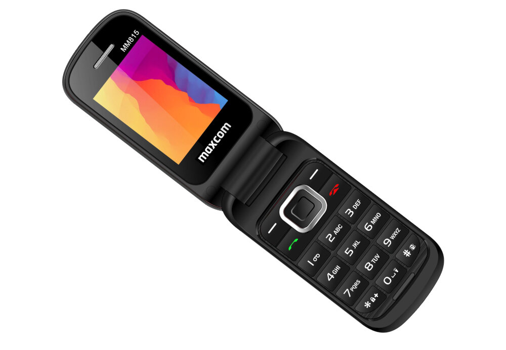 Telefon komórkowy z klapką w kolorze czarnym, z kolorowym wyświetlaczem i klawiaturą numeryczną. Na ekranie widoczny jest napis \'maxcom\'.