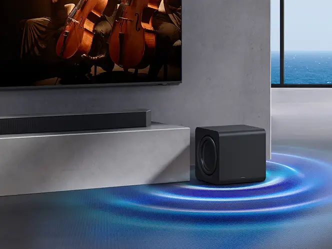 2026-hw-q930h-subwoofer 664x498 Soundbar Samsung HW-Q930H i subwoofer obok szafki RTV (Radio and Television) z niebieskimi kręgami dźwięku na podłodze.