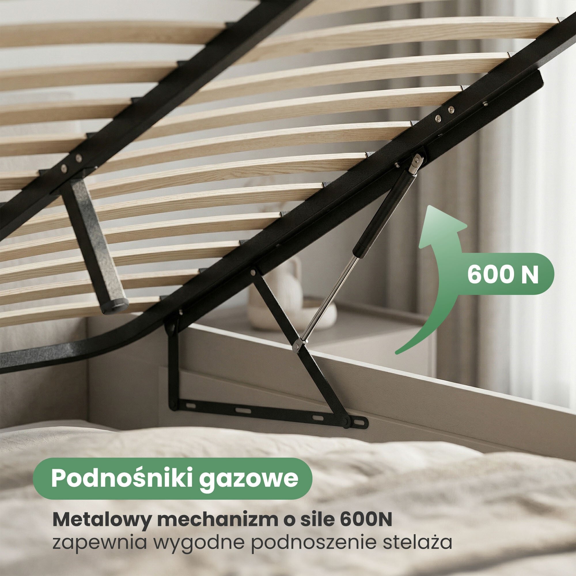 Zdjęcie przedstawia metalowy stelaż łóżka z mechanizmem podnoszenia, na którym widnieje tekst: \'Podnośniki gazowe Metalowy mechanizm o sile 600N zapewnia wygodne podnoszenie stelaża\'.