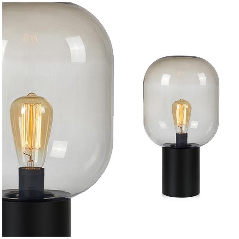 Lampa stołowa z przezroczystym kloszem w kształcie kopuły i widoczną żarówką wewnątrz, osadzona na czarnej, cylindrycznej podstawie.