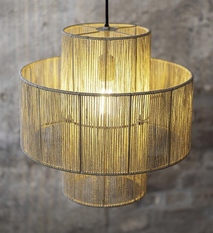 Lampa wisząca złożona z dwóch cylindrycznych abażurów wykonanych z cienkich, złotych prętów, przez które prześwituje światło żarówki. Tło stanowi szara, betonowa ściana.