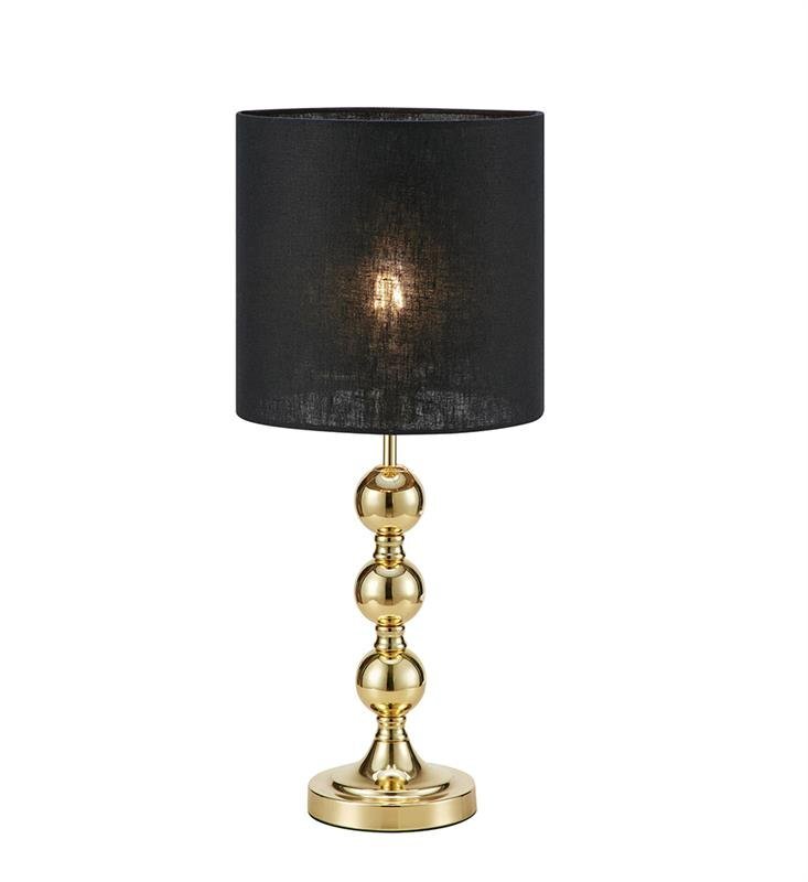 Lampa stołowa z czarnym abażurem i złotą podstawą o kulistym kształcie, umieszczona na białym tle.