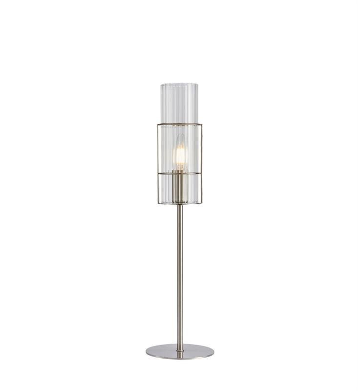 Lampa stołowa z przezroczystym, cylindrycznym kloszem i metalową podstawą. Wewnątrz klosza widoczna jest żarówka.
