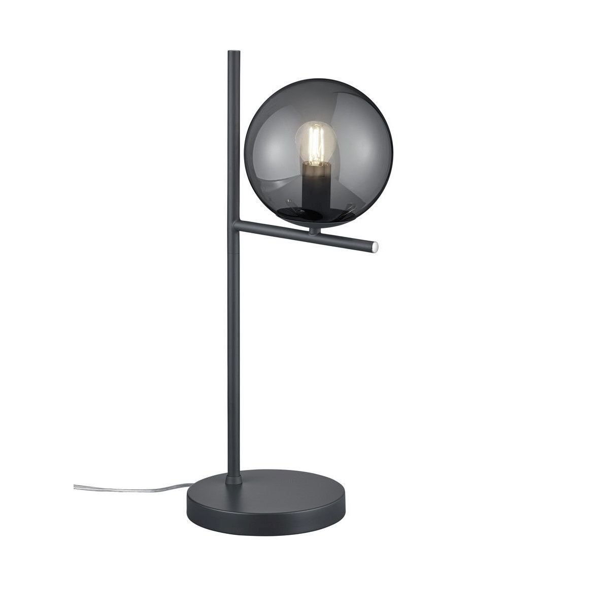 Lampa stołowa z okrągłym, przydymionym kloszem i metalową podstawą w nowoczesnym stylu. Widoczny przewód zasilający wychodzący z podstawy.