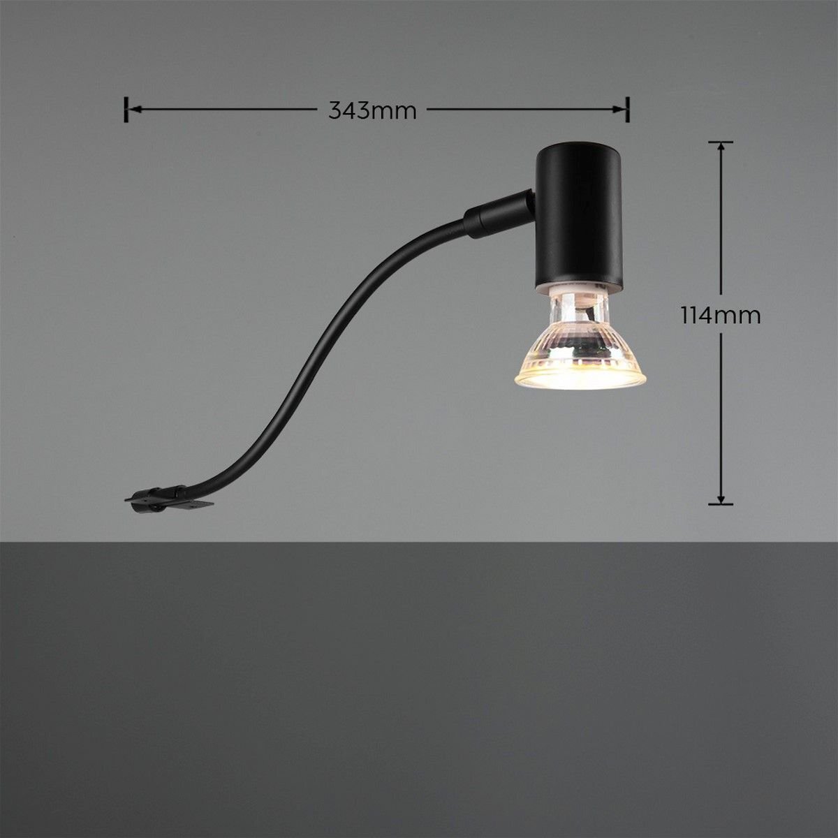 Czarna lampa nad lustro z przezroczystym kloszem, z wymiarami 343mm i 114mm, na szarym tle.