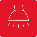 Czerwona ikona z białym konturem lampy sufitowej i promieniami światła.