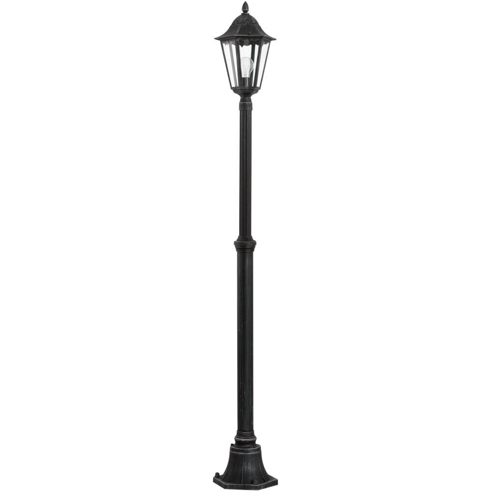 Czarna lampa masztowa zewnętrzna o klasycznym designie, z przezroczystym kloszem i widoczną żarówką wewnątrz. Lampa stoi na solidnej podstawie i ma ozdobne detale na szczycie.