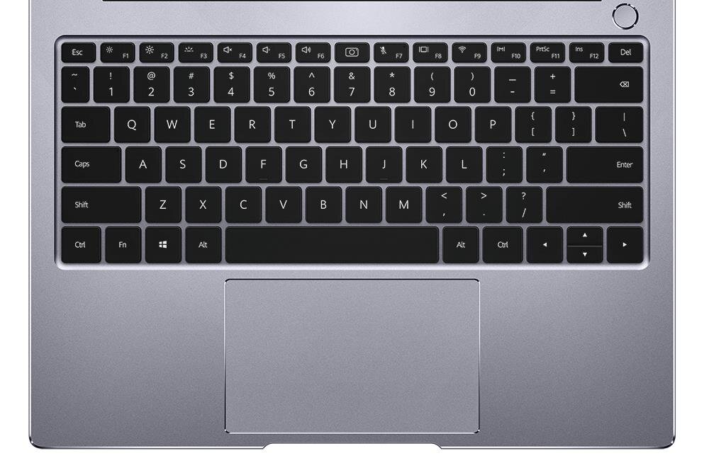 Obraz przedstawia klawiaturę laptopa z czarnymi klawiszami i srebrną obudową. Widoczny jest duży touchpad poniżej klawiatury.