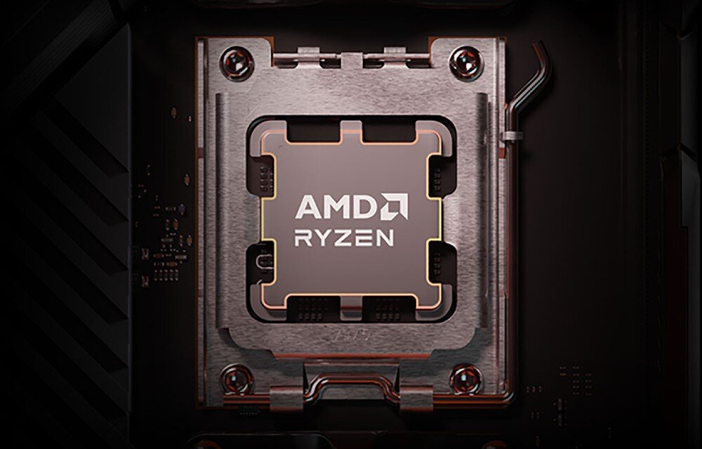 Na obrazie widoczny jest procesor z napisem \'AMD RYZEN\' zamontowany w gnieździe na płycie głównej. Procesor otoczony jest metalowym mocowaniem z czterema śrubami.