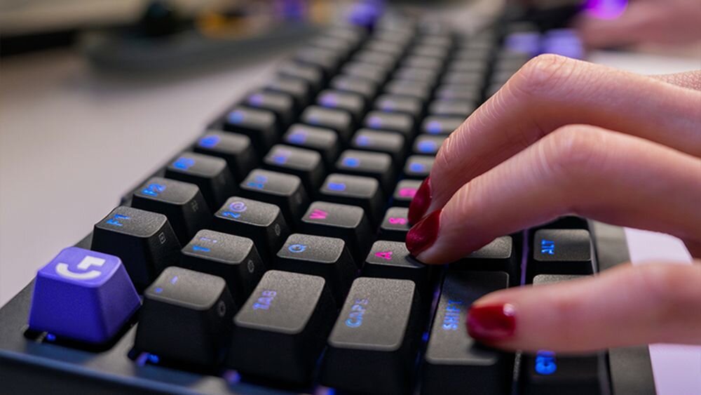 Klawiatura LOGITECH G512 X 75 punktu aktywacji w zakresie 0,1–4,0 mm Logitech G512 X 75 Rapid Trigger przełączników analogowych - Dłoń z pomalowanymi paznokciami pisząca na klawiaturze o niskim profilu