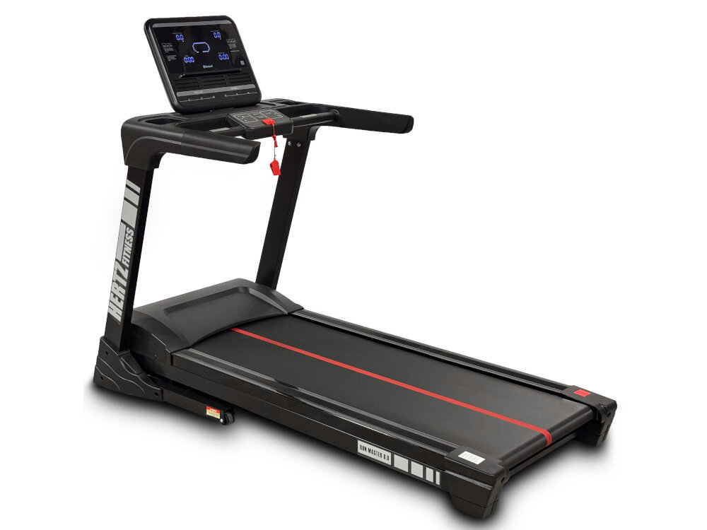 Na obrazie widoczna jest czarna bieżnia elektryczna z czerwonymi akcentami i dużym panelem sterującym. Na ramie bieżni znajduje się napis \'HERTZ FITNESS\'.