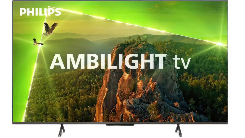 Telewizor z logo PHILIPS wyświetla obraz przedstawiający krajobraz górski z zielonym niebem i napisem \'AMBILIGHT tv\'.