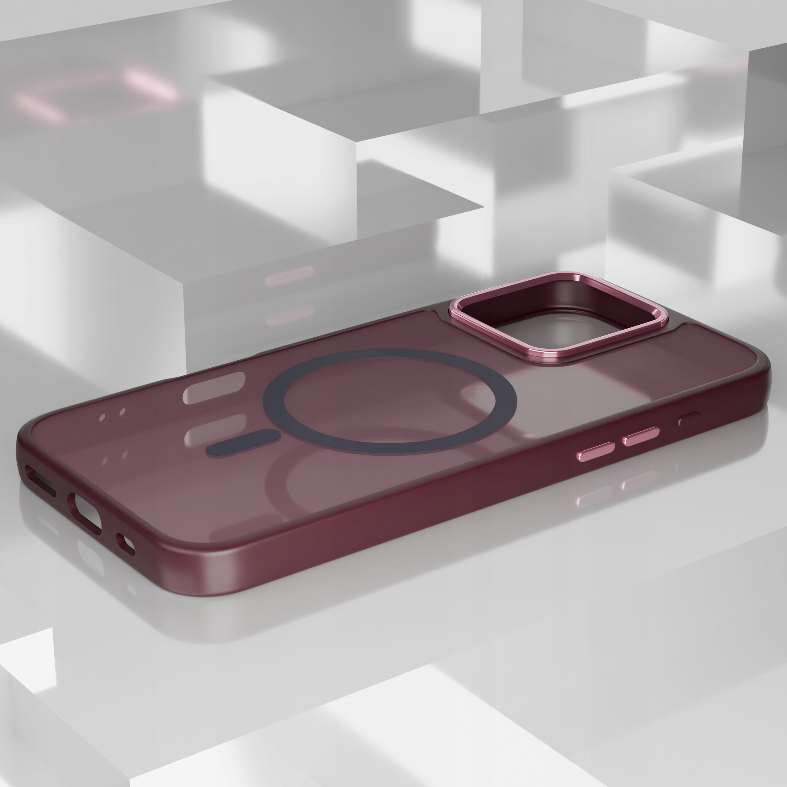 Etui do iPhone 16 Pro w kolorze bordowym, z okrągłym wzorem na środku i wycięciem na aparat, leży na błyszczącej, geometrycznej powierzchni.