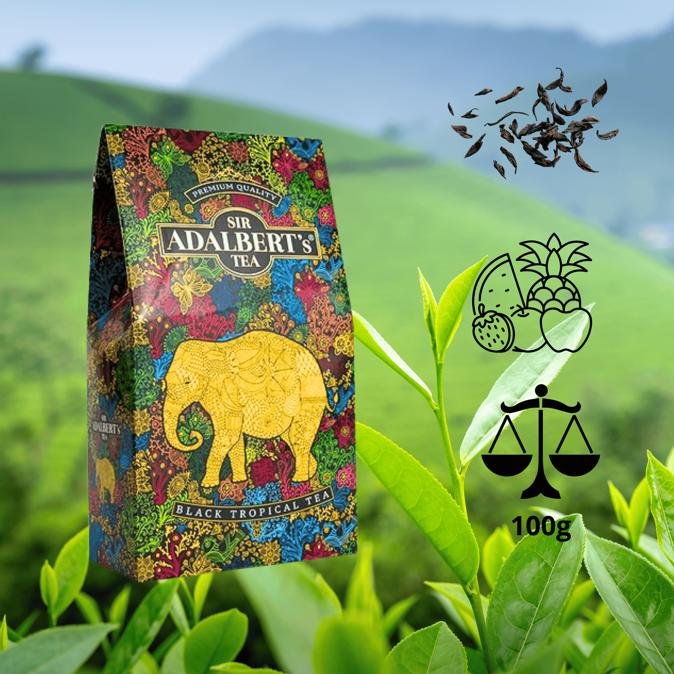 Opakowanie herbaty Sir Adalbert’s Black Tropical Tea z kolorowym wzorem i złotym słoniem na tle zielonych liści herbaty. Obok widoczne są symbole owoców tropikalnych, waga z napisem \'100g\' oraz rozsypane liście herbaty.