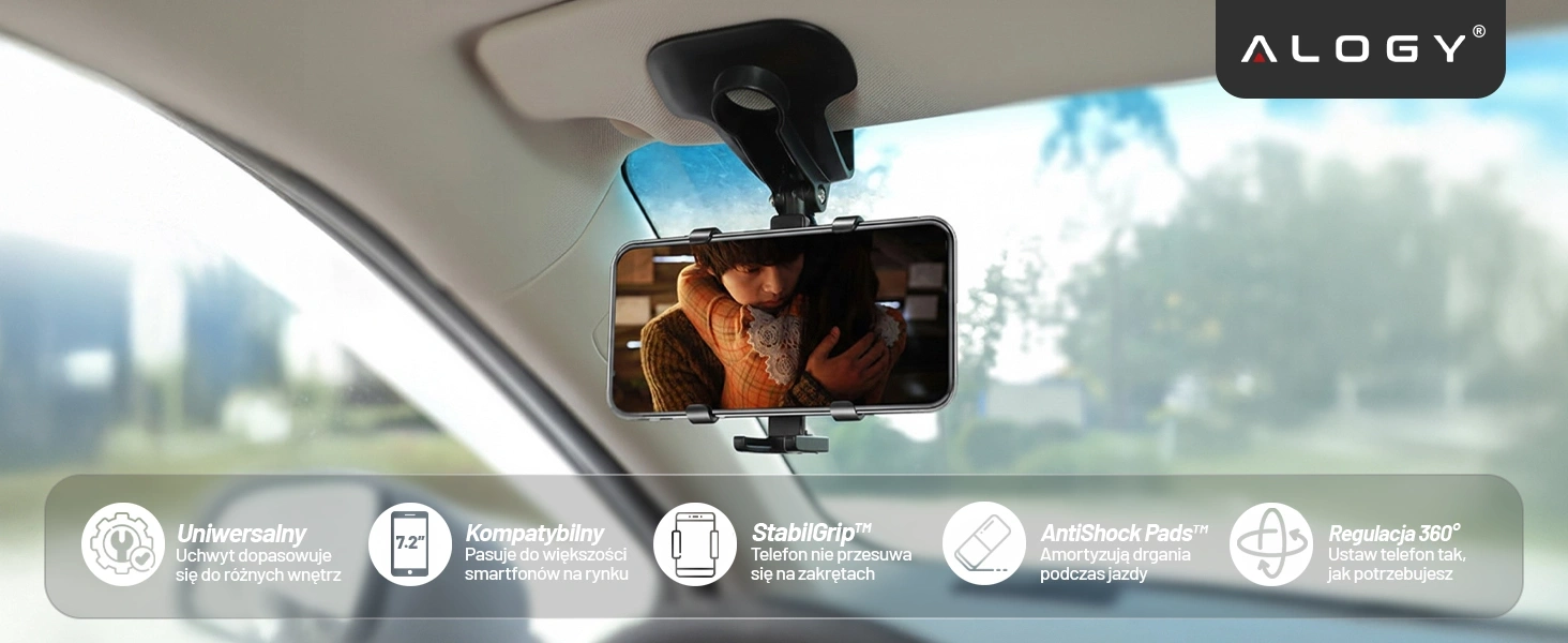 Uchwyt samochodowy na telefon zamontowany na lusterku wstecznym, trzymający smartfon z wyświetlanym filmem. Na dole widoczne są ikony z tekstem: \'Uniwersalny Uchwyt dopasowuje się do różnych wnętrz\', \'Kompatybilny Pasuje do większości smartfonów na rynku\', \'StabilGrip™ Telefon nie przesuwa się na zakrętach\', \'AntiShock Pads™ Amortyzują drgania podczas jazdy\', \'Regulacja 360° Ustaw telefon tak, jak potrzebujesz\'.