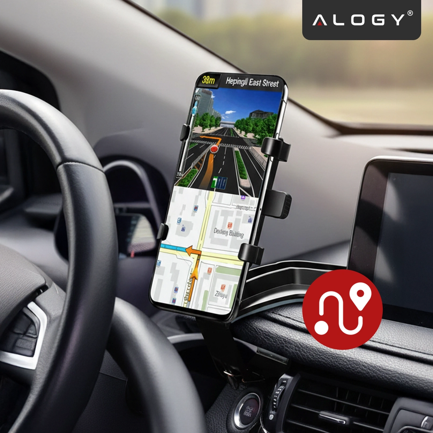 Uchwyt samochodowy na telefon zamontowany na desce rozdzielczej, trzymający smartfon z włączoną nawigacją. W prawym górnym rogu widoczne jest logo \'ALOGY\'.