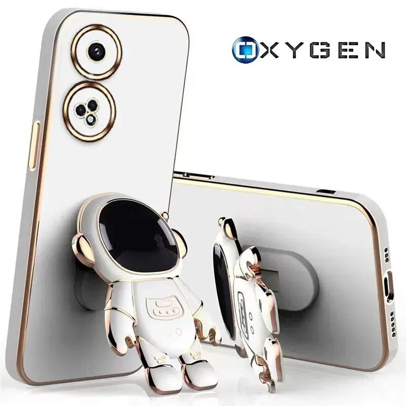 Na obrazie widoczne są dwa etui na telefon z motywem astronauty, jedno stojące, drugie leżące. W prawym górnym rogu znajduje się logo \'OXYGEN\'.