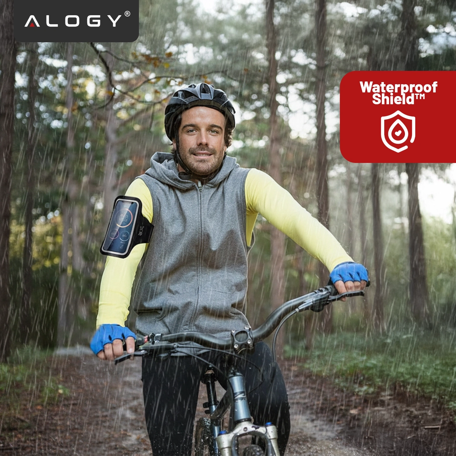 Osoba na rowerze w deszczu, z opaską na ramię na telefon. Widoczne logo \'ALOGY\' i napis \'Waterproof Shield™\'.