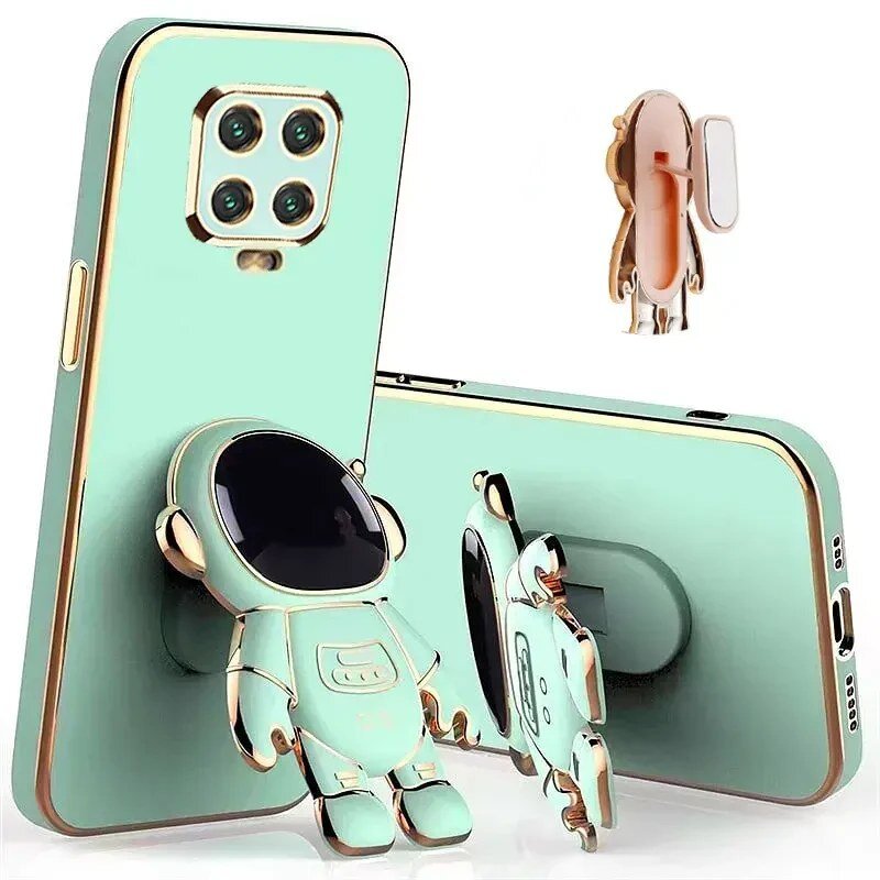 Obraz przedstawia etui na telefon w kolorze miętowym z metalicznymi akcentami, z uchwytem w kształcie astronauty. Etui posiada wycięcia na aparat i porty, a uchwyt astronauty jest przymocowany do tylnej części etui.